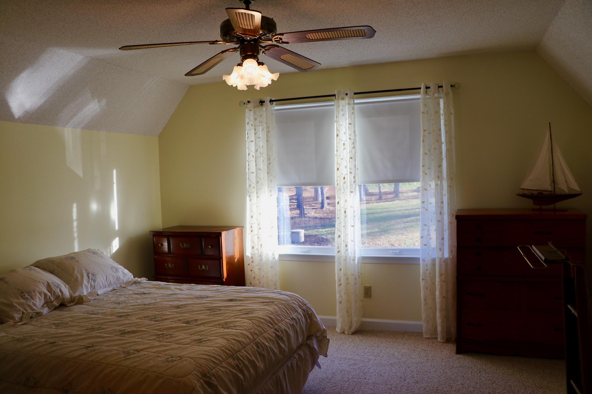 3571 Kemp Ford Road Union Hall, VA 24176 - Photo 14 of 102 a bedroom with a bed and a chandelier