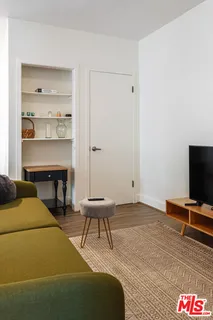 a kitchen with appliances cabinets and a potted plant