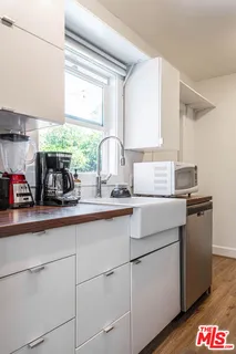 a kitchen with kitchen island granite countertop cabinets and wooden floor