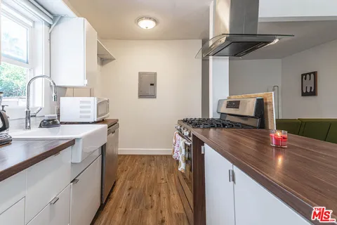 a kitchen with a sink stove and refrigerator