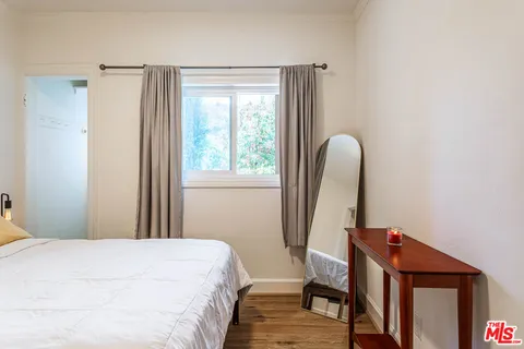 a bedroom with a bed and lamp