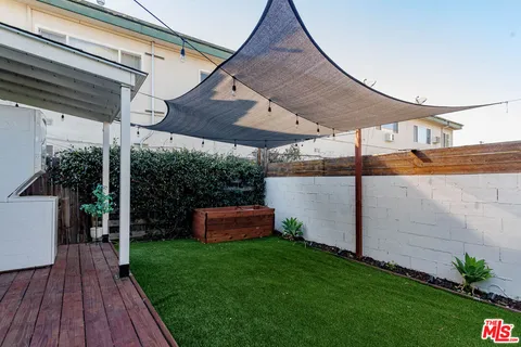 a backyard of a house with outdoor seating and green space