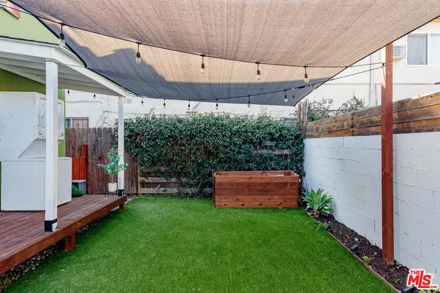 a view of a backyard with wooden fence