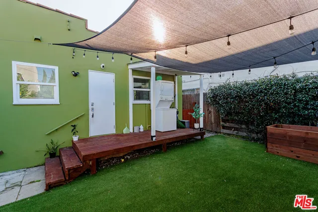 a view of a backyard with plants and a patio