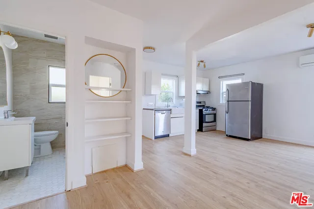 a kitchen with appliances a sink and a window