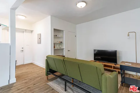 a work room with furniture and wooden floor