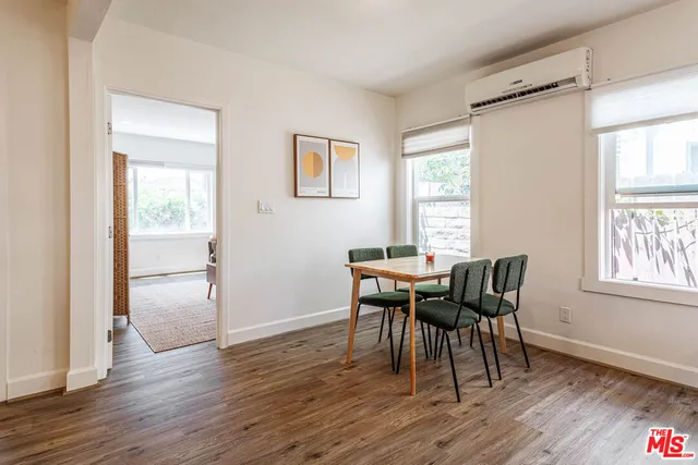 a living room with furniture a couch and two windows