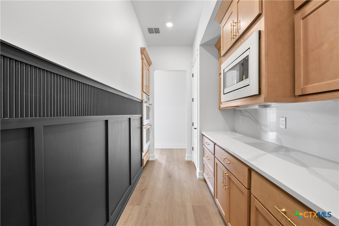 6807 Lacey Oak Road Salado, TX 76571 - Photo 11 of 41 a kitchen with stainless steel appliances granite countertop a refrigerator and a sink