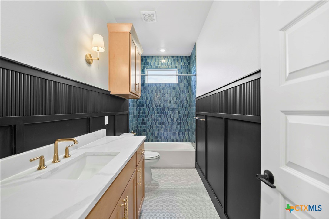 6807 Lacey Oak Road Salado, TX 76571 - Photo 17 of 41 a bathroom with a sink a toilet and shower