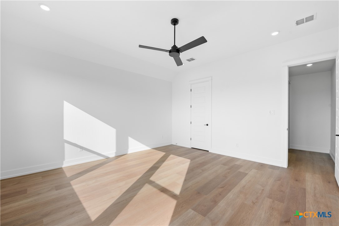 6807 Lacey Oak Road Salado, TX 76571 - Photo 22 of 41 a bedroom with a bed and a chandelier