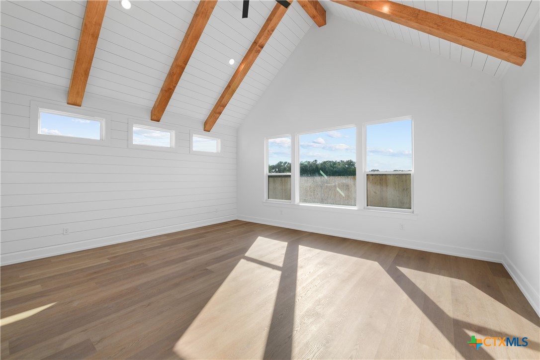 6807 Lacey Oak Road Salado, TX 76571 - Photo 25 of 41 a view of an empty room with wooden floor and a window