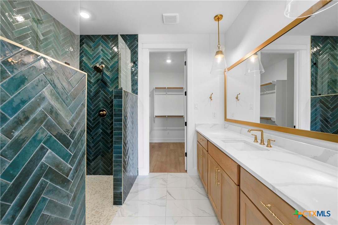 6807 Lacey Oak Road Salado, TX 76571 - Photo 30 of 41 a bathroom with a sink and a mirror