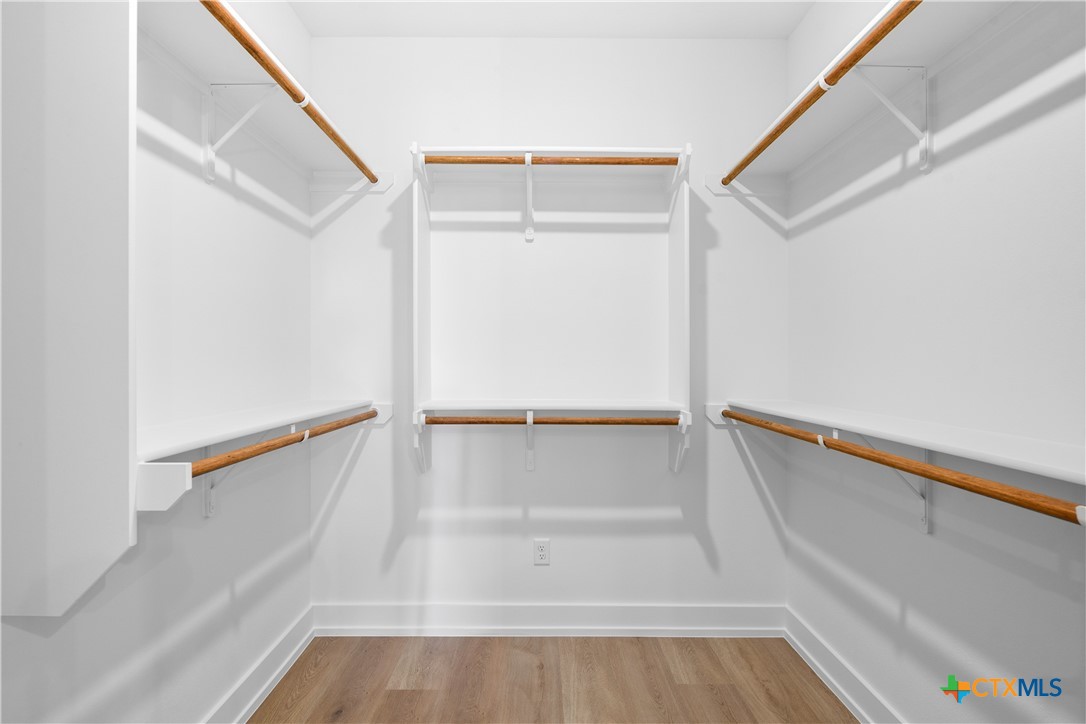 6807 Lacey Oak Road Salado, TX 76571 - Photo 34 of 41 a view of walk in closet with empty racks