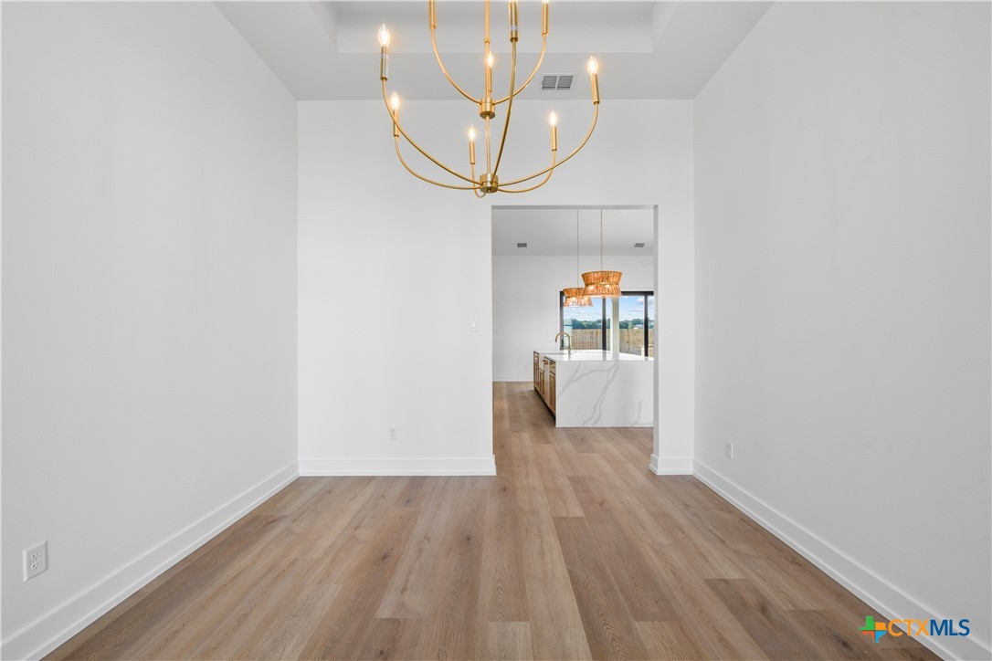 6807 Lacey Oak Road Salado, TX 76571 - Photo 7 of 41 a view of a hallway view with wooden floor and staircase