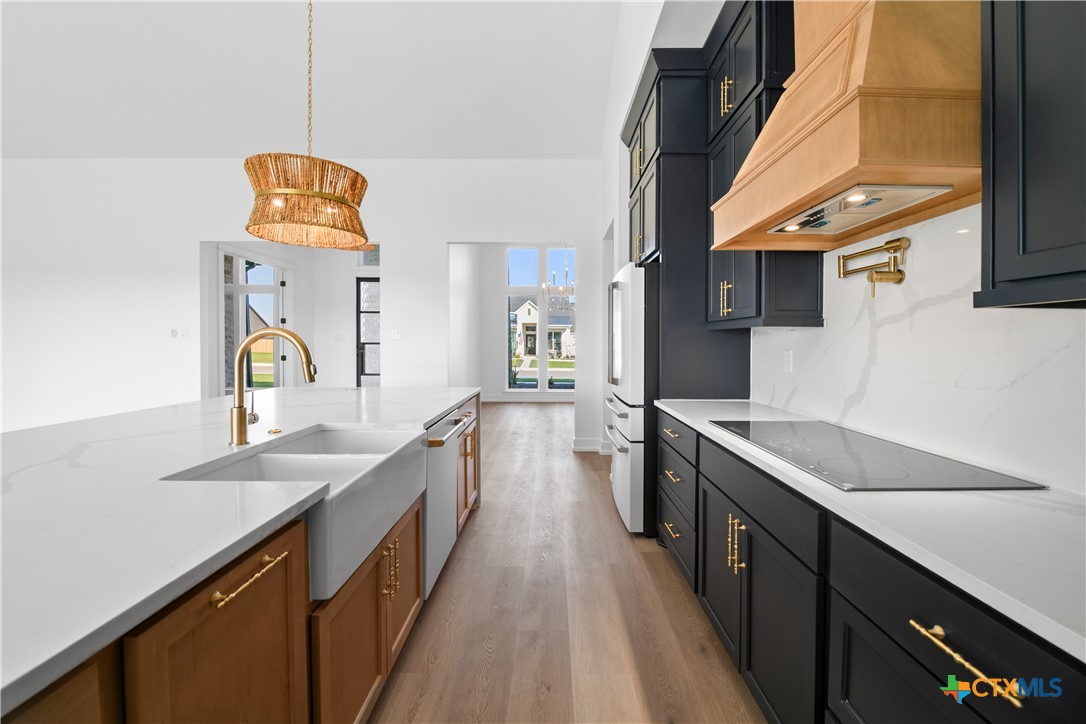 6807 Lacey Oak Road Salado, TX 76571 - Photo 9 of 41 a kitchen with a sink and a stove top oven