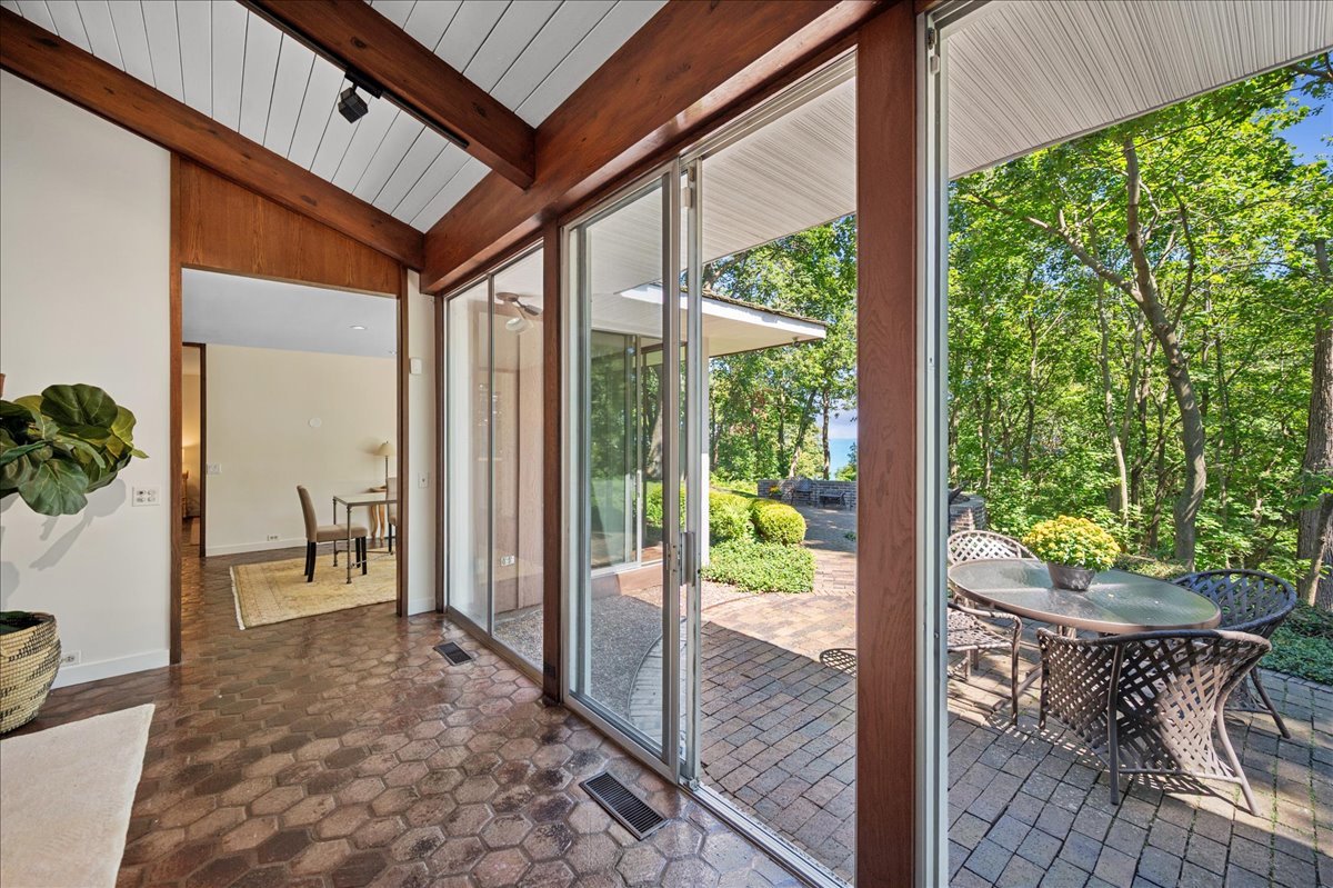 1045 Hillcrest Road Glencoe, IL 60022 - Photo 11 of 32 a view of a porch with furniture and floor to ceiling window