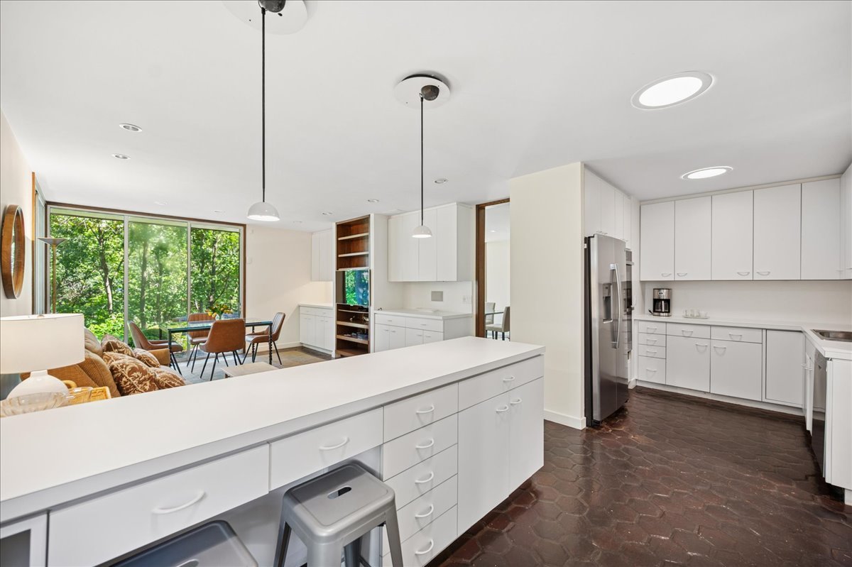 1045 Hillcrest Road Glencoe, IL 60022 - Photo 14 of 32 a kitchen with stainless steel appliances kitchen island granite countertop a refrigerator a sink a stove and white cabinets with wooden floor