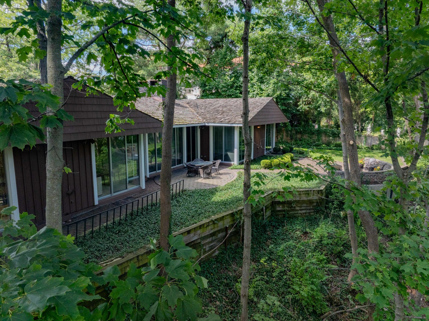 1045 Hillcrest Road Glencoe, IL 60022 - Photo 26 of 32 front view of a house with a yard table and chairs