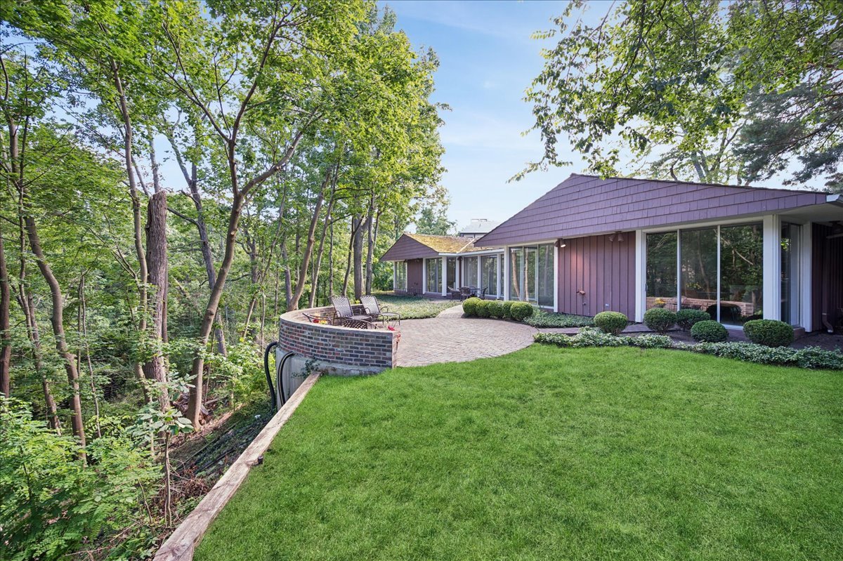 1045 Hillcrest Road Glencoe, IL 60022 - Photo 6 of 32 a front view of a house with a yard and porch