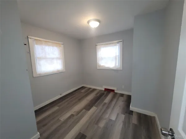 a view of a room with wooden floor and stairs