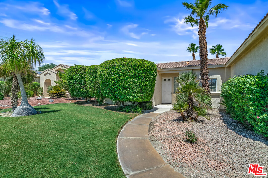68420 Riviera Road Cathedral City, CA 92234 - Photo 1 of 42 a front view of a house with garden
