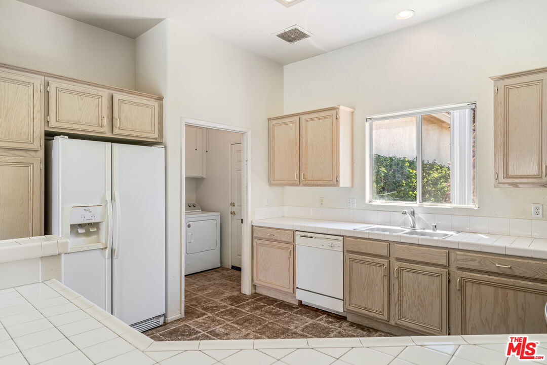 68420 Riviera Road Cathedral City, CA 92234 - Photo 15 of 42 a kitchen with a sink cabinets and appliances