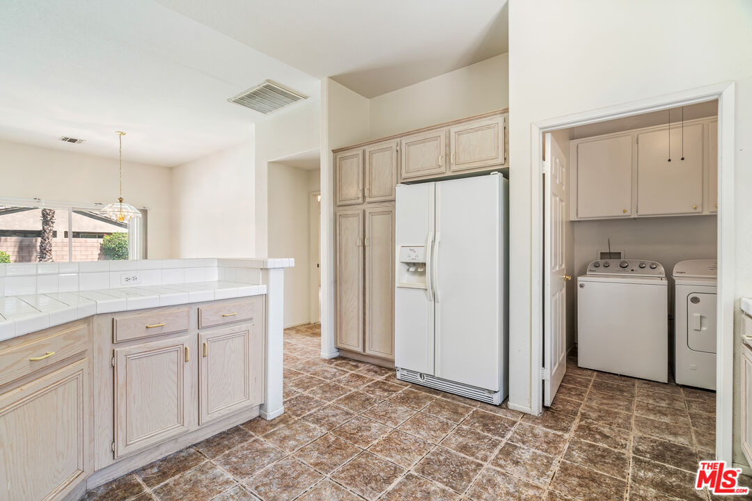 68420 Riviera Road Cathedral City, CA 92234 - Photo 16 of 42 a view of a kitchen with white cabinets