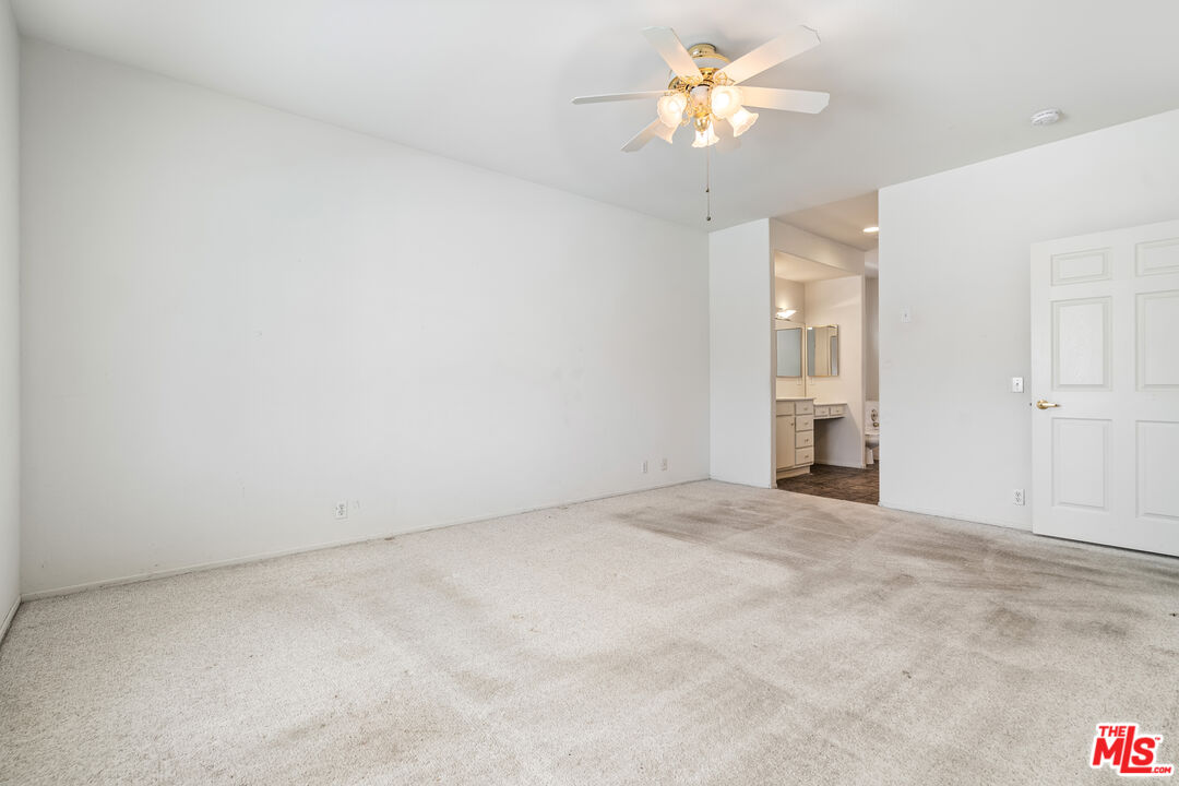 68420 Riviera Road Cathedral City, CA 92234 - Photo 20 of 42 an empty room with closet and a chandelier fan