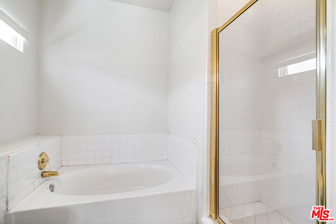 68420 Riviera Road Cathedral City, CA 92234 - Photo 23 of 42 a white bath tub sitting next to a shower