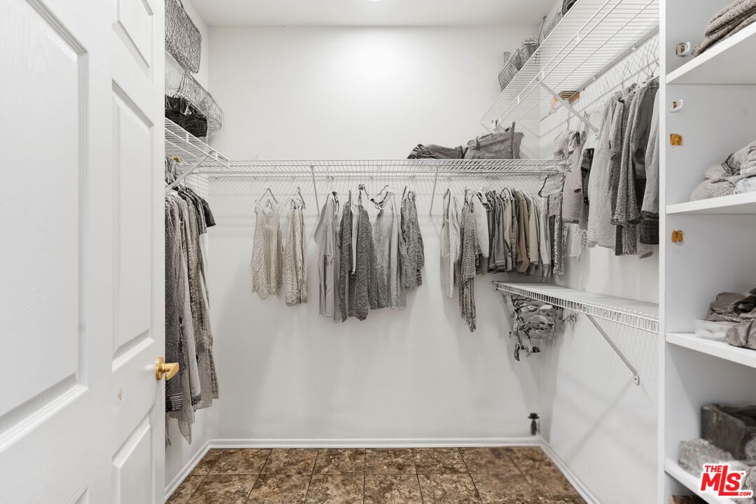 68420 Riviera Road Cathedral City, CA 92234 - Photo 24 of 42 a view of walk in closet with clothes and shoes