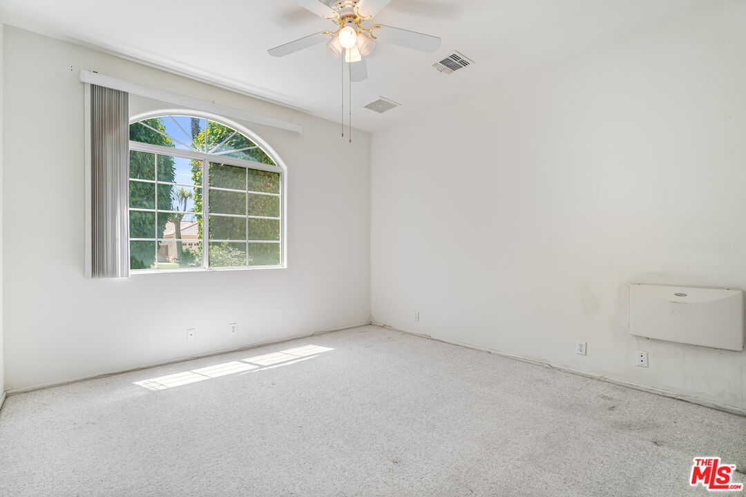 68420 Riviera Road Cathedral City, CA 92234 - Photo 31 of 42 an empty room with a window