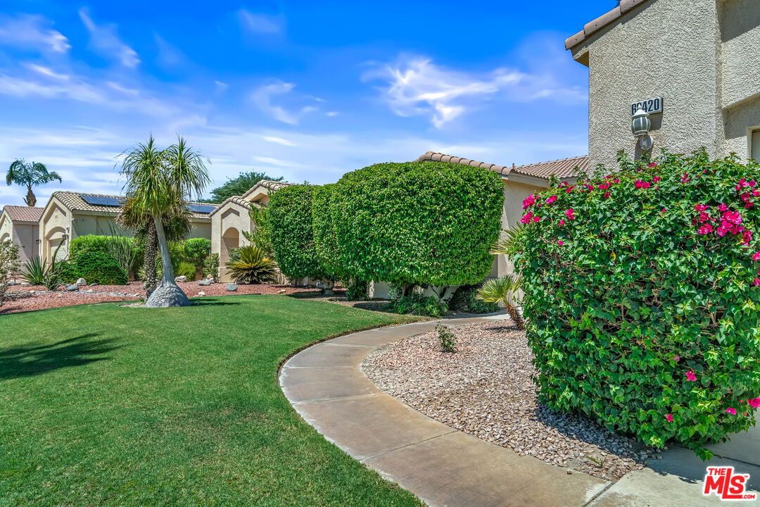 68420 Riviera Road Cathedral City, CA 92234 - Photo 4 of 42 a view of a garden with a building in the background