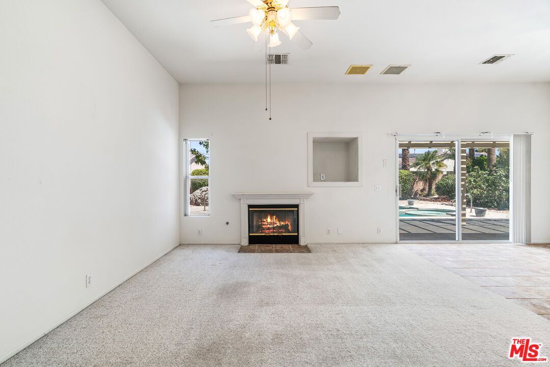 68420 Riviera Road Cathedral City, CA 92234 - Photo 5 of 42 a living room with furniture and a chandelier