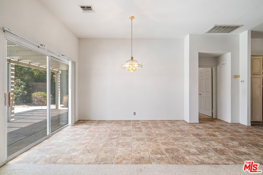 68420 Riviera Road Cathedral City, CA 92234 - Photo 10 of 42 a view of a room with wooden floor and white walls