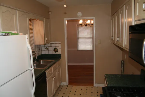 a kitchen with a sink a refrigerator and a stove