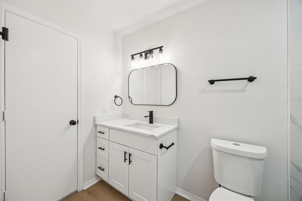 5909 Mark Lane Rowlett, TX 75089 - Photo 15 of 28 a bathroom with a sink toilet and mirror