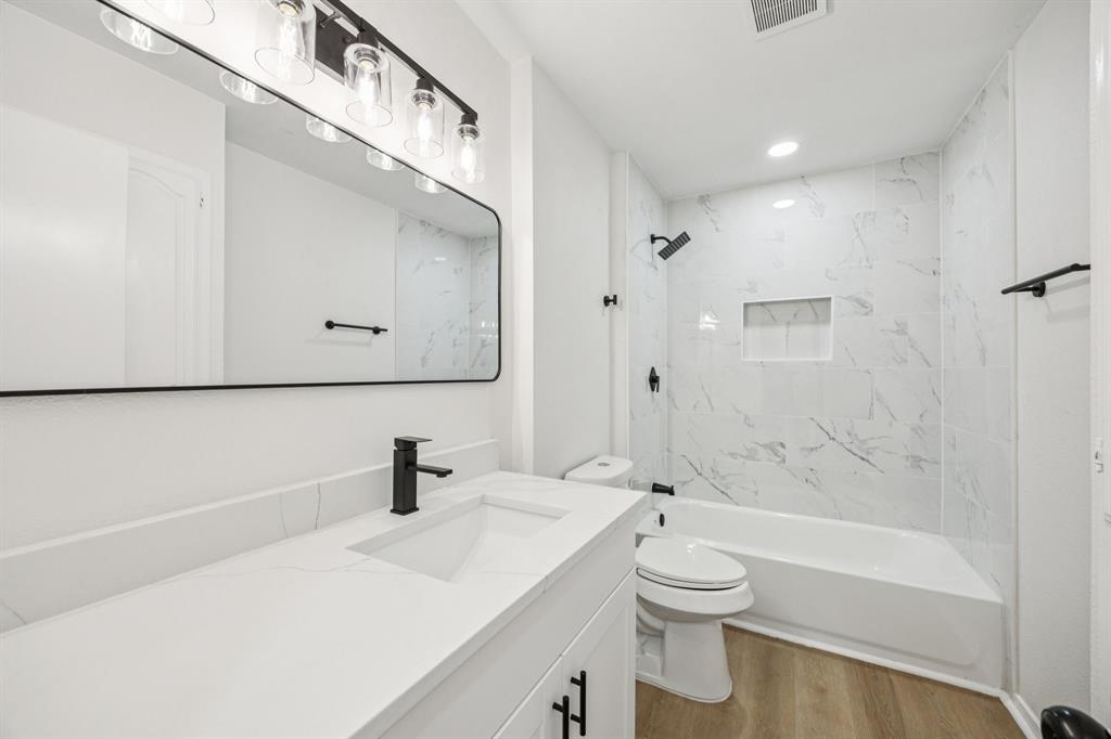 5909 Mark Lane Rowlett, TX 75089 - Photo 21 of 28 a bathroom with a sink a toilet and shower