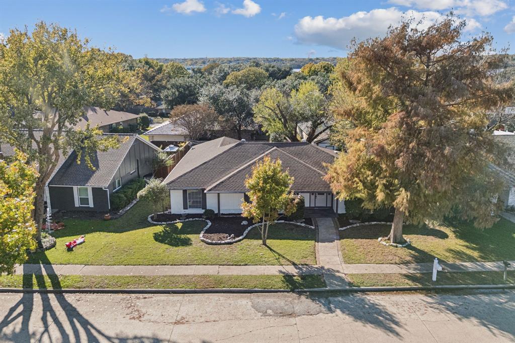 5909 Mark Lane Rowlett, TX 75089 - Photo 27 of 28 a view of a house with a yard