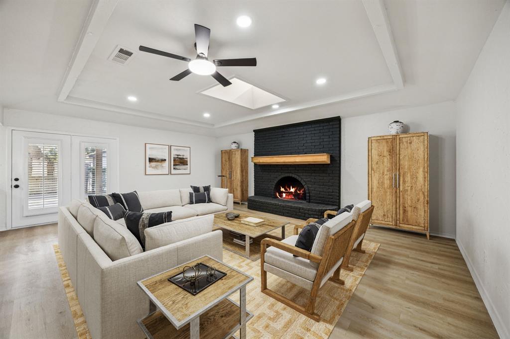 5909 Mark Lane Rowlett, TX 75089 - Photo 4 of 28 a living room with furniture a flat screen tv and a fireplace