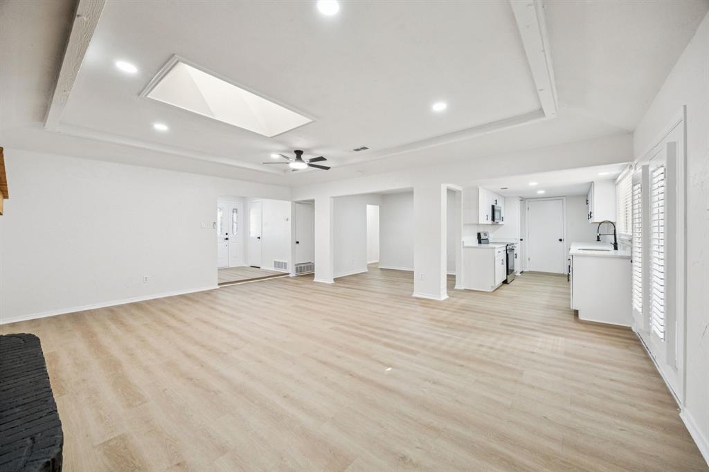 5909 Mark Lane Rowlett, TX 75089 - Photo 7 of 28 a view of a big room with wooden cabinet and windows