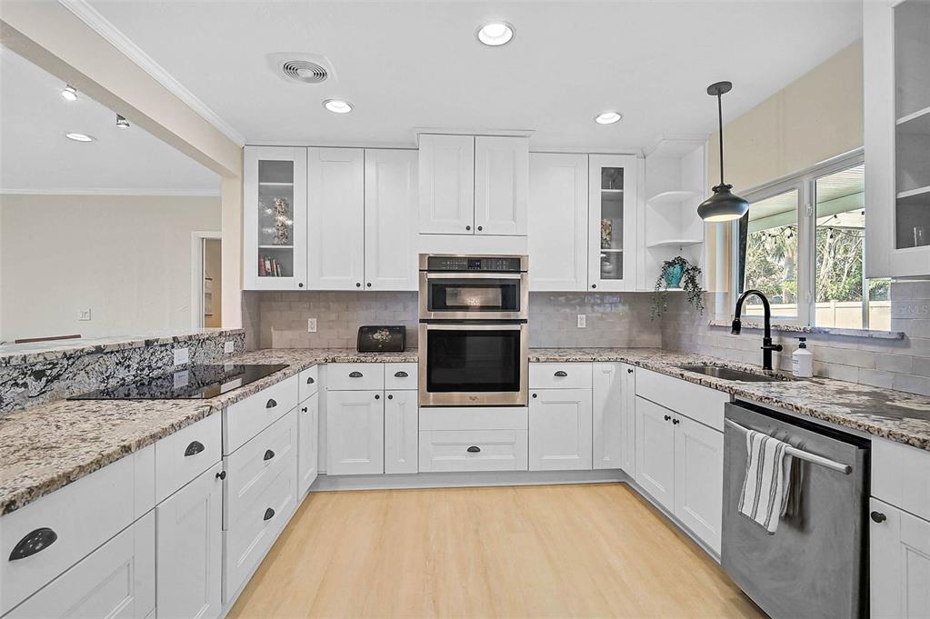 1099 Nokomis Avenue South Venice, FL 34285 - Photo 12 of 68 a kitchen with granite countertop a sink stainless steel appliances and cabinets