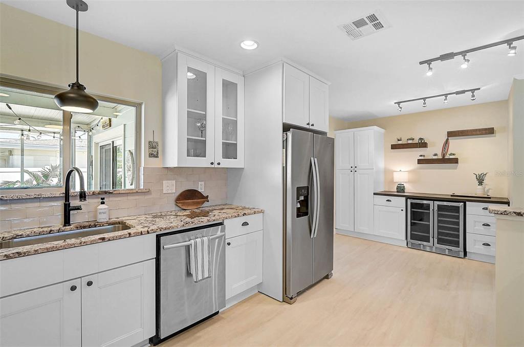 1099 Nokomis Avenue South Venice, FL 34285 - Photo 13 of 68 a kitchen with granite countertop a refrigerator stove top oven and sink