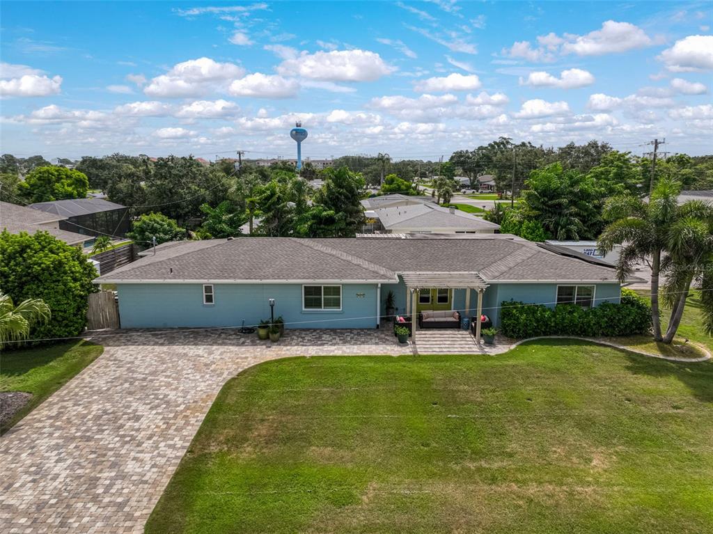 1099 Nokomis Avenue South Venice, FL 34285 - Photo 2 of 68 a aerial view of a house with swimming pool and a yard