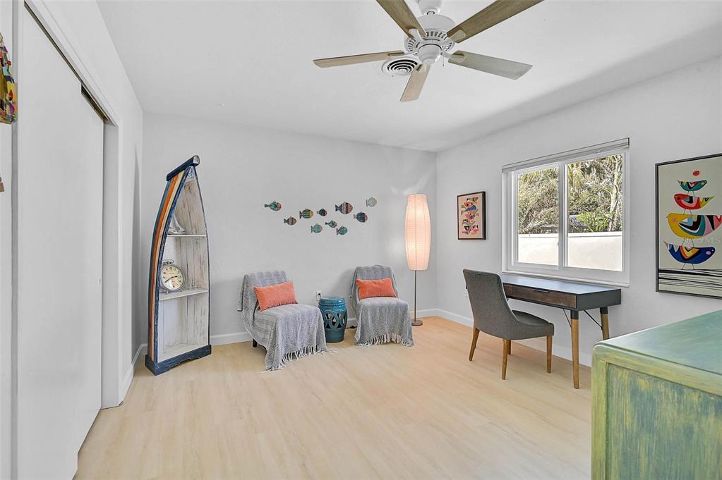 1099 Nokomis Avenue South Venice, FL 34285 - Photo 22 of 68 a bedroom with furniture and a window