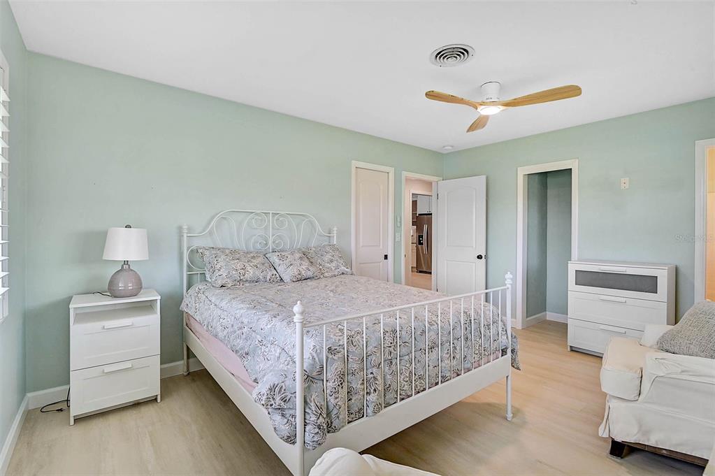 1099 Nokomis Avenue South Venice, FL 34285 - Photo 25 of 68 a bedroom with a bed and a couch