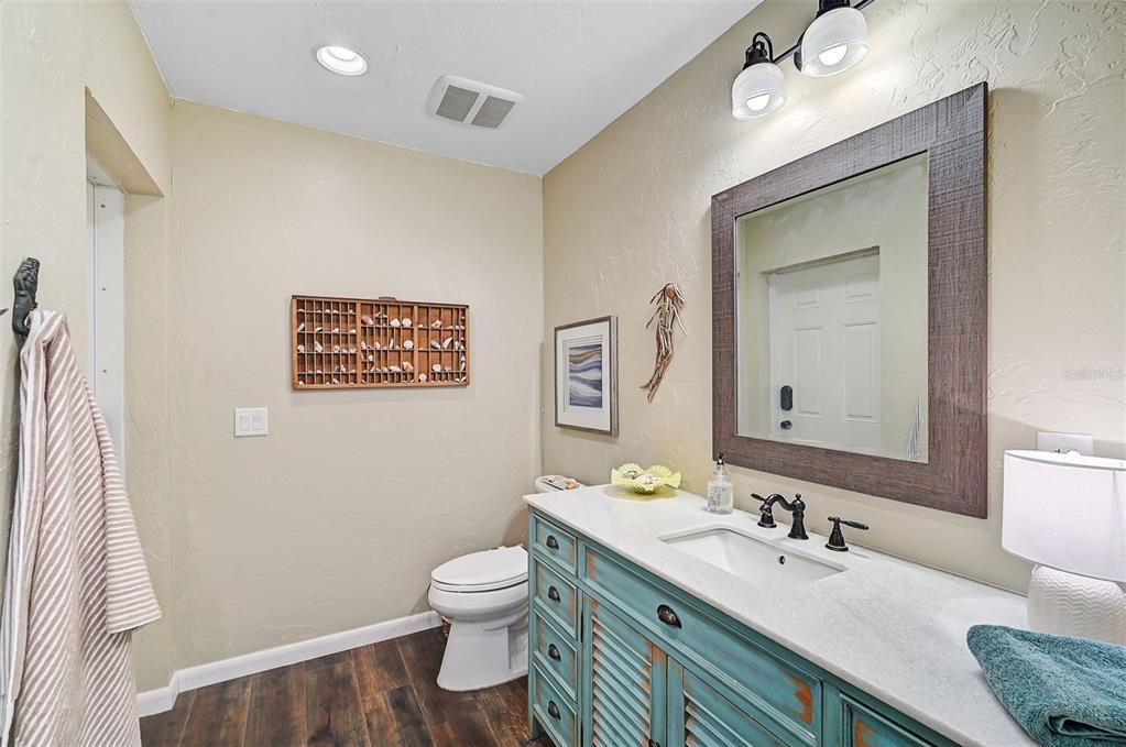 1099 Nokomis Avenue South Venice, FL 34285 - Photo 28 of 68 a bathroom with a granite countertop sink mirror vanity and toilet