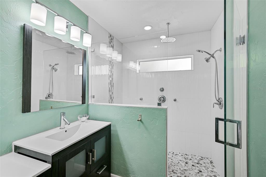 1099 Nokomis Avenue South Venice, FL 34285 - Photo 32 of 68 a bathroom with a sink and a mirror