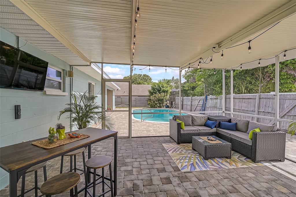 1099 Nokomis Avenue South Venice, FL 34285 - Photo 35 of 68 a patio with patio couch and wooden floor