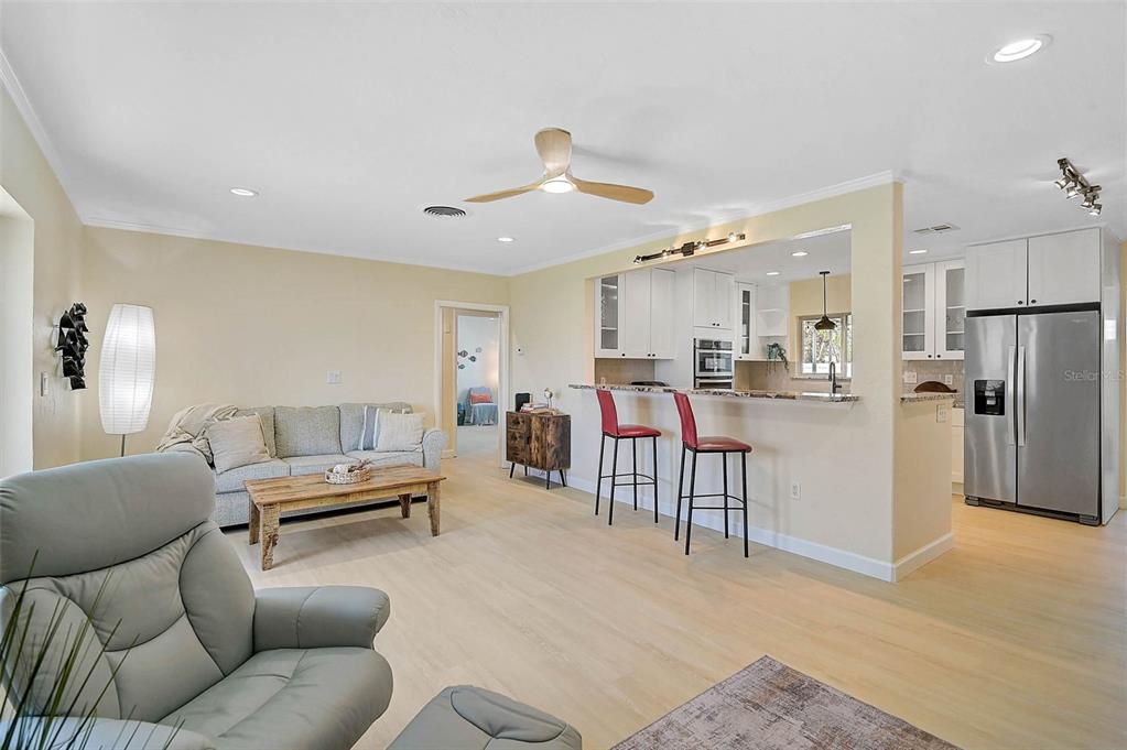 1099 Nokomis Avenue South Venice, FL 34285 - Photo 5 of 68 a living room with furniture and kitchen view