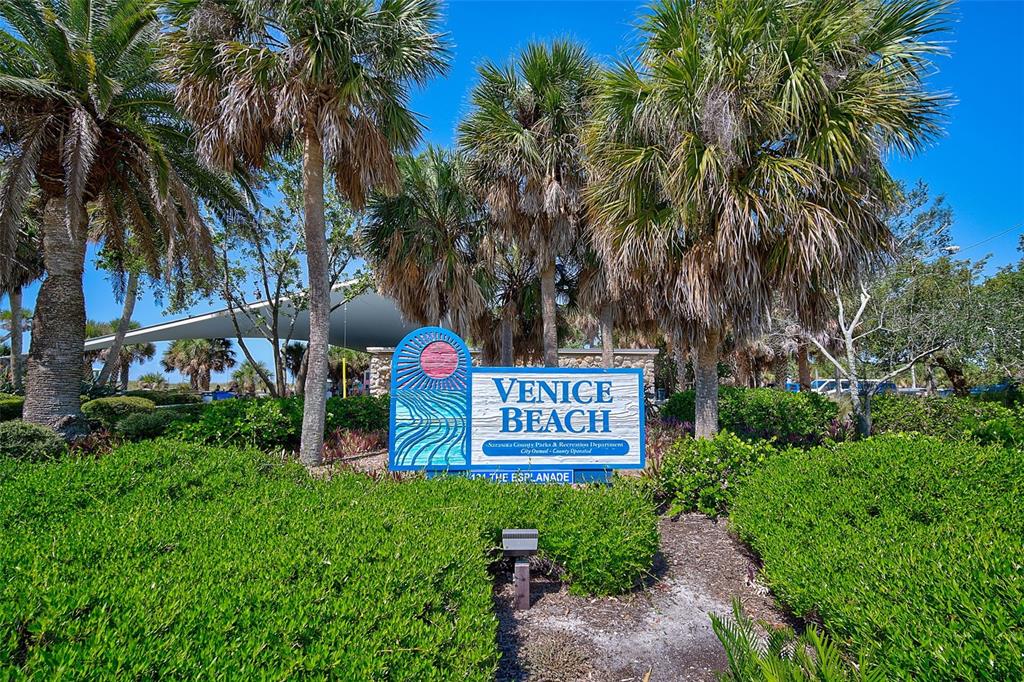 1099 Nokomis Avenue South Venice, FL 34285 - Photo 51 of 68 a sign that is sitting on a brick wall with a palm trees